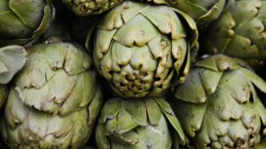 A photo of artichokes piled on top of one another as the size of the baby at 18 weeks pregnant